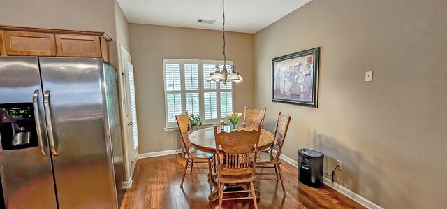 62 Mabel Ln, Atoka, TN 38004 - dining space with a chandelier, wood finished floors, and baseboards