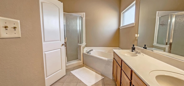 62 Mabel Ln, Atoka, TN 38004 - full bath with tile patterned floors, a stall shower, a bath, double vanity, and a textured wall