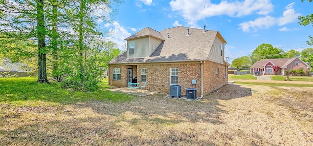 62 Mabel Ln, Atoka, TN 38004 - back of house with central air condition unit, brick siding, a patio, and roof with shingles