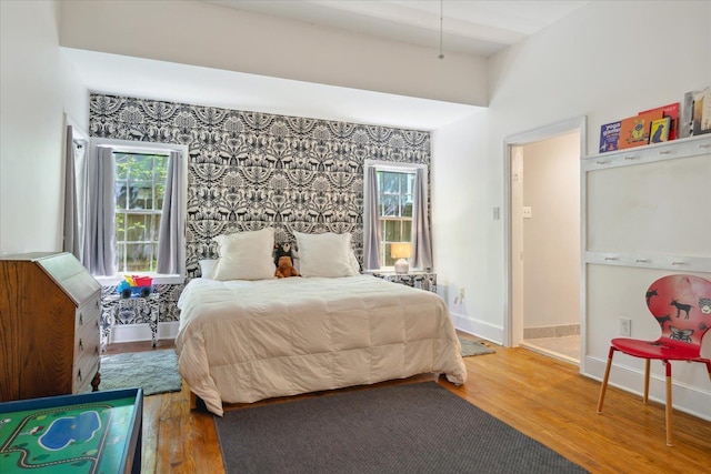 bedroom featuring baseboards and wood finished floors