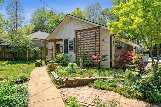 exterior space featuring fence and an attached garage