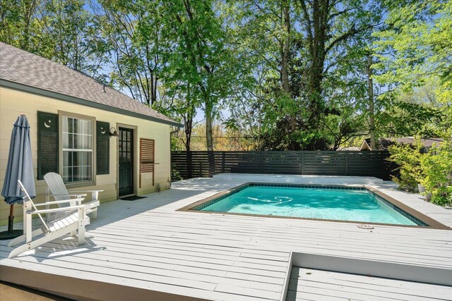 view of pool featuring a wooden deck, a fenced in pool, and a fenced backyard