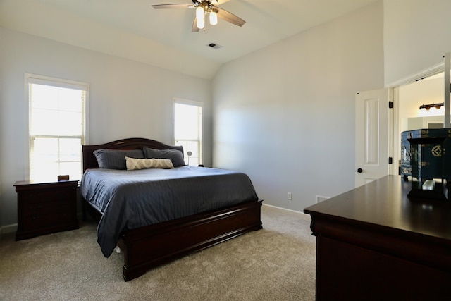 bedroom featuring vaulted ceiling, visible vents, light carpet, baseboards, and ceiling fan