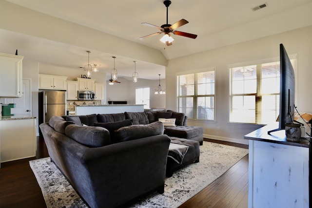 living room featuring vaulted ceiling, a ceiling fan, baseboards, dark wood-style flooring, and visible vents
