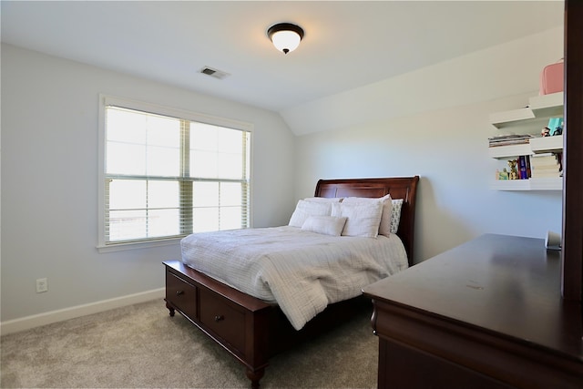 bedroom featuring baseboards, carpet flooring, vaulted ceiling, and visible vents