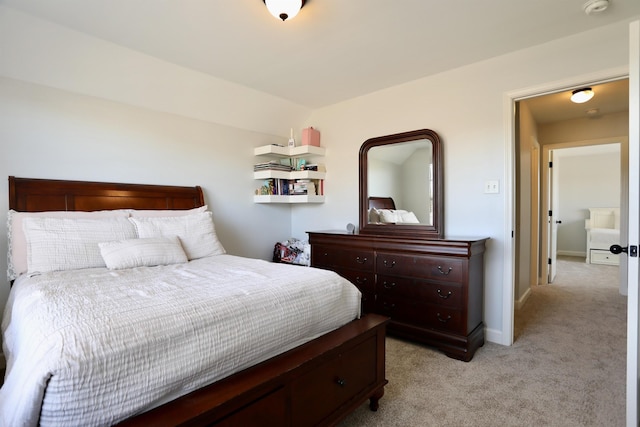 bedroom featuring baseboards and light carpet