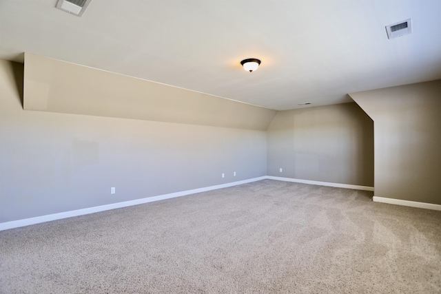 bonus room with baseboards, visible vents, and carpet floors