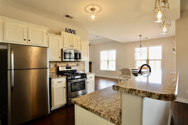 kitchen with decorative backsplash, baseboards, dark wood-style flooring, and stainless steel appliances