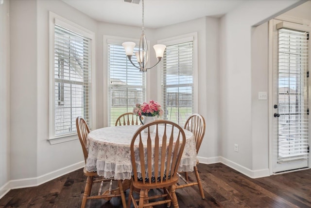 dining room featuring baseboards, a chandelier, and a healthy amount of sunlight