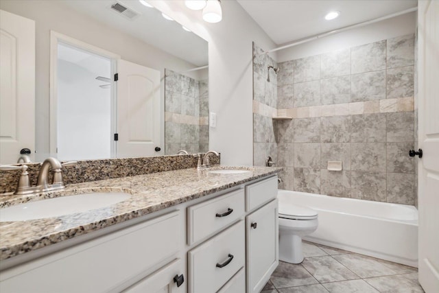 full bathroom featuring double vanity, visible vents, toilet, and a sink