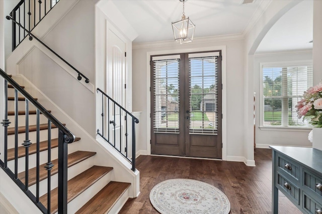 entrance foyer featuring french doors, baseboards, dark wood finished floors, and crown molding