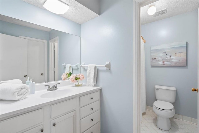 bathroom with vanity, tile patterned floors, toilet, visible vents, and a textured ceiling