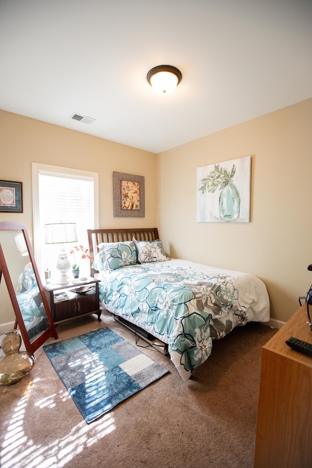 bedroom with visible vents and carpet