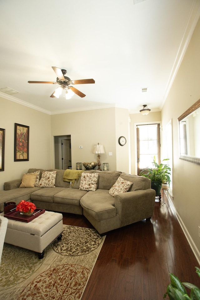 living area with dark wood-type flooring, ceiling fan, baseboards, and ornamental molding