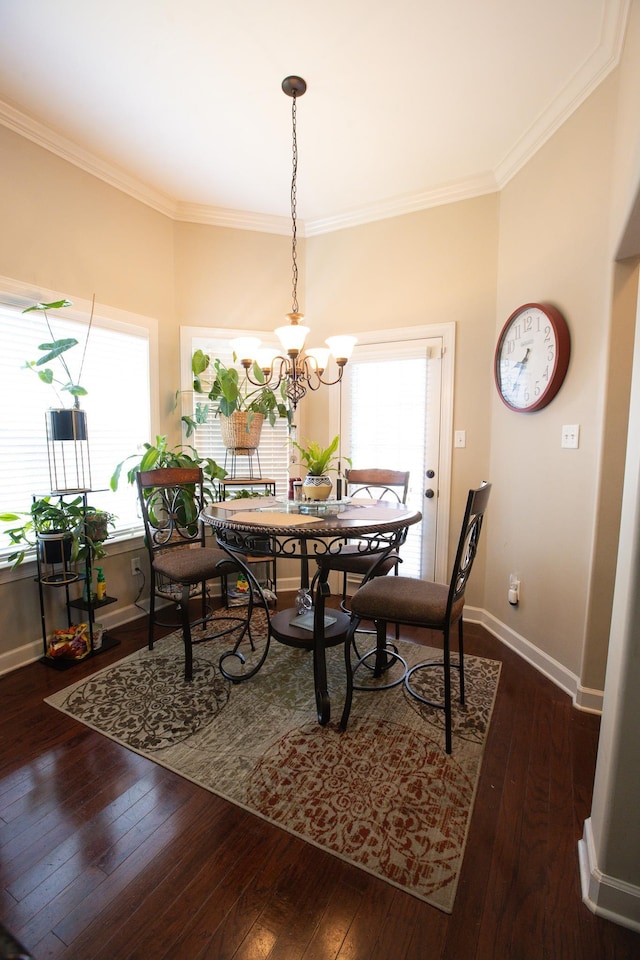 dining space featuring a chandelier, dark wood finished floors, and crown molding
