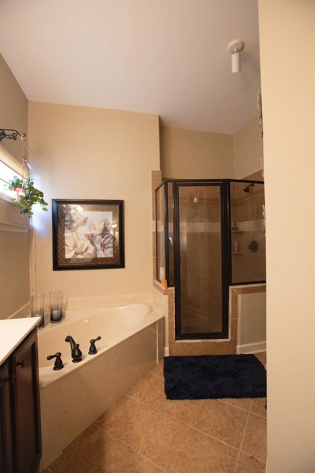full bathroom with tile patterned floors, a garden tub, vanity, and a stall shower
