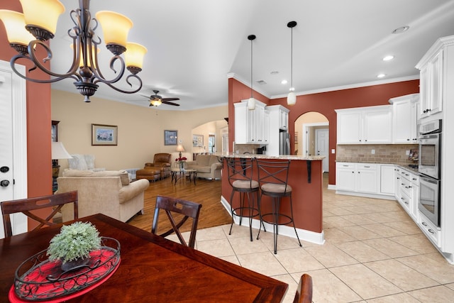 325 Fairoaks Dr, Oakland, TN 38060 - dining area with arched walkways, light tile patterned floors, and ceiling fan with notable chandelier