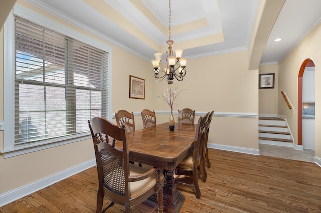 325 Fairoaks Dr, Oakland, TN 38060 - dining room with light wood-style floors, arched walkways, a chandelier, and ornamental molding