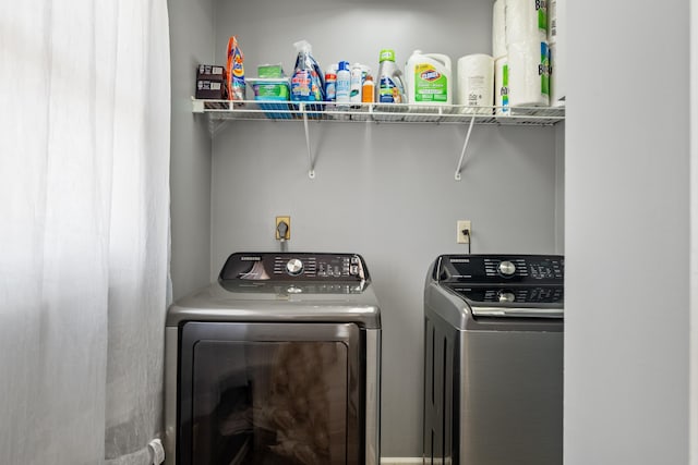 clothes washing area featuring washing machine and dryer and laundry area