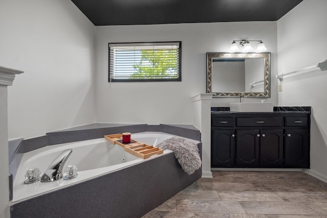 bathroom featuring a garden tub and vanity
