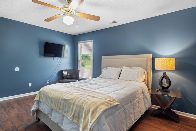 bedroom featuring ceiling fan, baseboards, wood finished floors, and visible vents