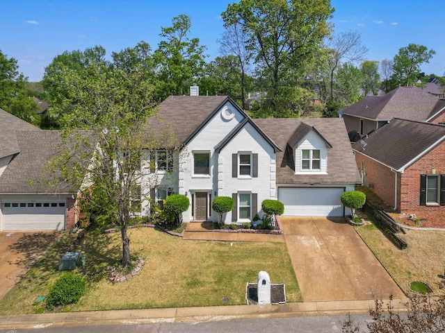 traditional-style home featuring brick siding, driveway, and a front yard