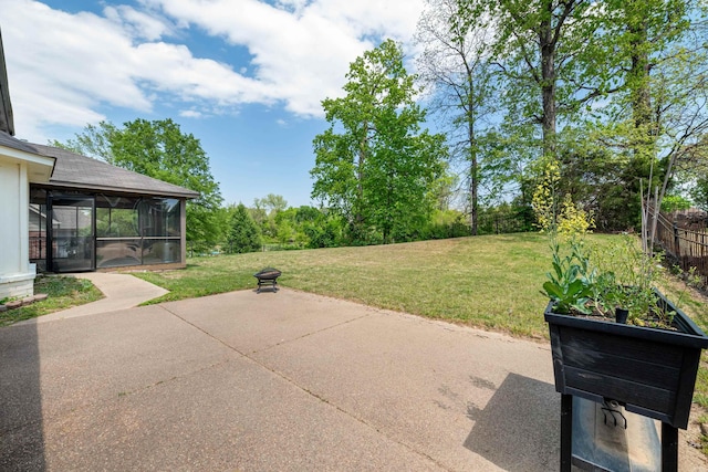 view of patio / terrace featuring a sunroom and fence
