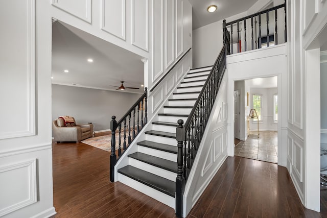 stairway featuring wood finished floors, recessed lighting, and ceiling fan