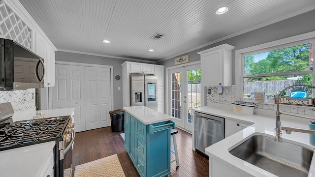 kitchen with white cabinetry, french doors, stainless steel appliances, and a sink
