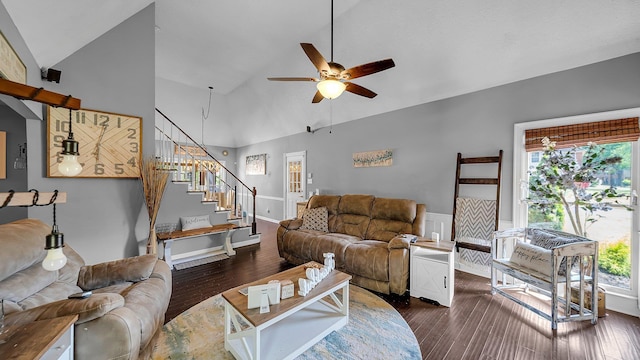 living room featuring dark wood finished floors, plenty of natural light, stairs, and ceiling fan