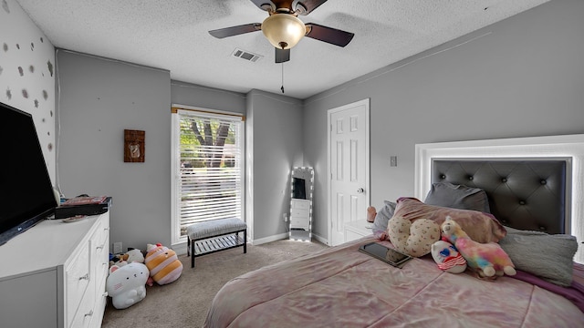bedroom featuring visible vents, carpet floors, baseboards, a textured ceiling, and ceiling fan