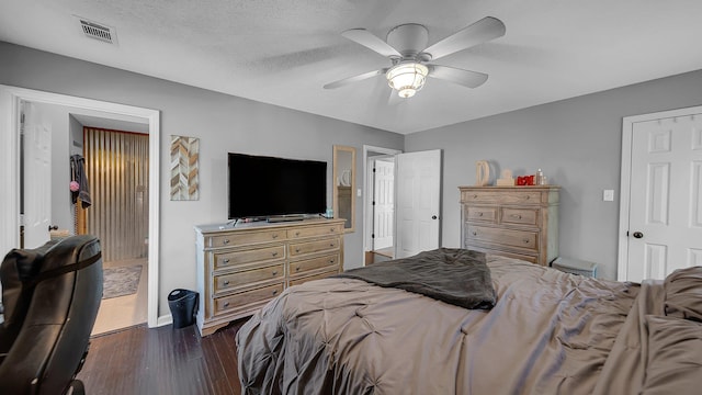 bedroom featuring dark wood finished floors, baseboards, ceiling fan, and visible vents