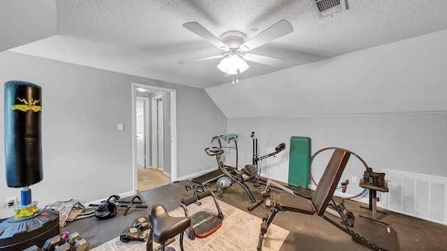 exercise room featuring ceiling fan, vaulted ceiling, visible vents, and baseboards