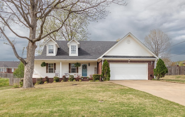 cape cod home with a front lawn, covered porch, concrete driveway, fence, and an attached garage
