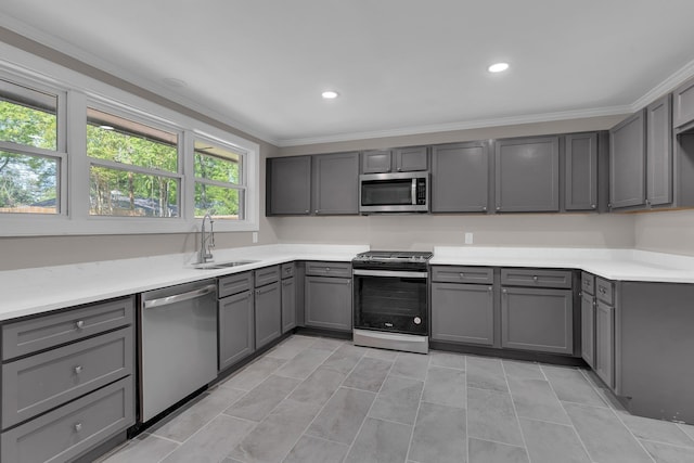 5188 Gwynne Rd, Memphis, TN 38117 - kitchen with stainless steel appliances, light countertops, gray cabinets, a sink, and crown molding