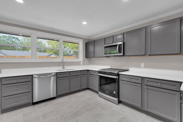 5188 Gwynne Rd, Memphis, TN 38117 - kitchen with stainless steel appliances, light countertops, ornamental molding, a sink, and gray cabinetry
