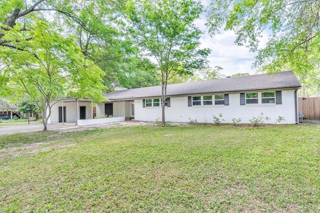 5188 Gwynne Rd, Memphis, TN 38117 - view of front of house with a front lawn, driveway, fence, and an attached carport