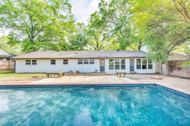 5188 Gwynne Rd, Memphis, TN 38117 - rear view of house with a fenced in pool, a chimney, fence, brick siding, and a deck