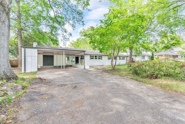 5188 Gwynne Rd, Memphis, TN 38117 - ranch-style home featuring a chimney, a carport, and aphalt driveway