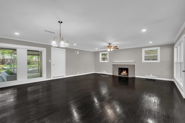 5188 Gwynne Rd, Memphis, TN 38117 - unfurnished living room featuring ceiling fan with notable chandelier, visible vents, ornamental molding, and a fireplace with flush hearth