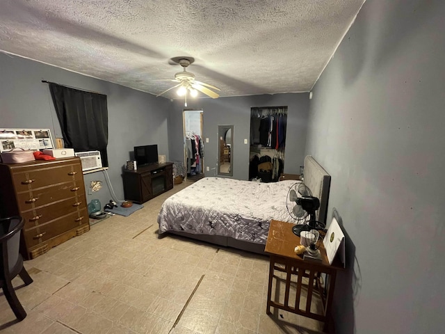 bedroom featuring a ceiling fan and a textured ceiling