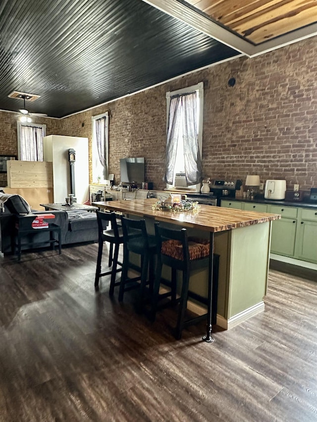 132 W Court Ave, Selmer, TN 38375 - interior space with dark wood finished floors, wooden ceiling, and brick wall