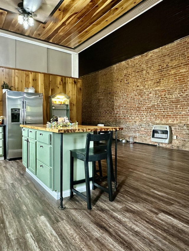132 W Court Ave, Selmer, TN 38375 - interior space featuring heating unit, green cabinets, butcher block counters, dark wood finished floors, and stainless steel refrigerator with ice dispenser