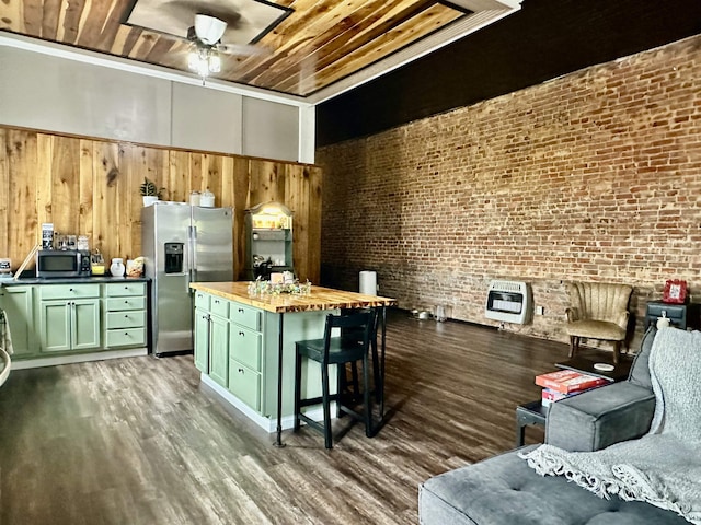 132 W Court Ave, Selmer, TN 38375 - kitchen with dark wood finished floors, green cabinetry, heating unit, appliances with stainless steel finishes, and ceiling fan