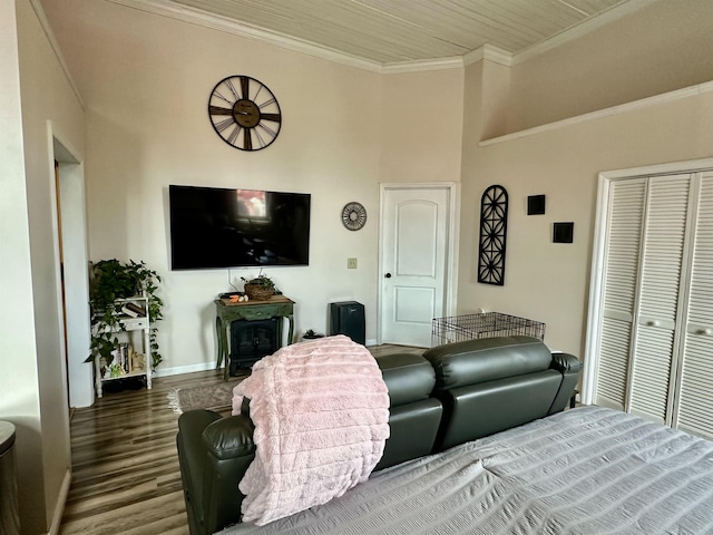 132 W Court Ave, Selmer, TN 38375 - interior space featuring baseboards, crown molding, a wood stove, and wood finished floors