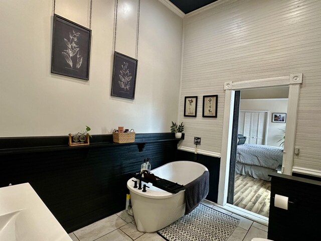 132 W Court Ave, Selmer, TN 38375 - full bathroom with tile patterned floors, ensuite bathroom, a freestanding bath, a high ceiling, and ornamental molding