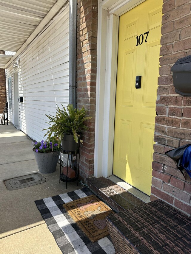 132 W Court Ave, Selmer, TN 38375 - doorway to property featuring covered porch and brick siding