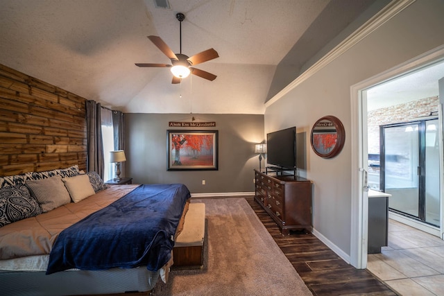 bedroom with lofted ceiling, wooden walls, wood finished floors, access to exterior, and baseboards