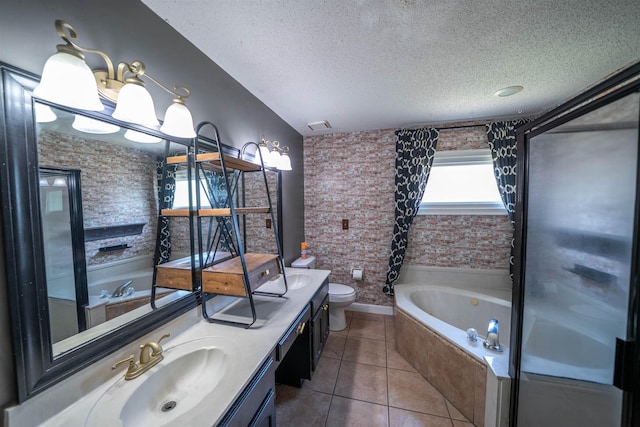 full bathroom featuring tile patterned floors, a textured ceiling, a sink, a tub to relax in, and toilet