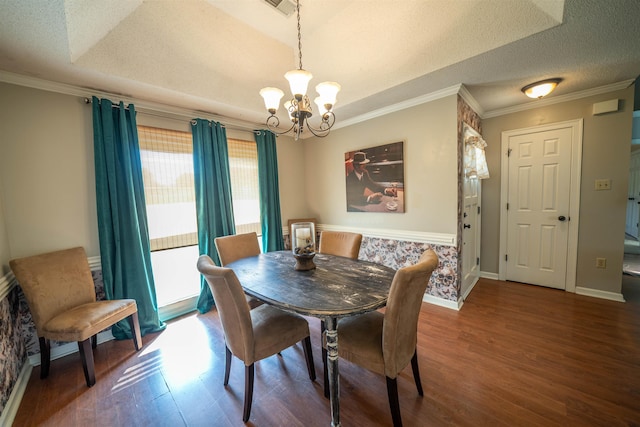 dining area featuring a chandelier, wood finished floors, crown molding, and baseboards